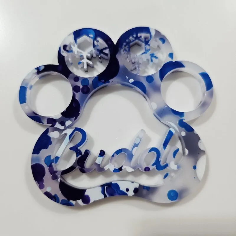 Buddy paw ornament cut from designer acrylic with blue and white paint drops